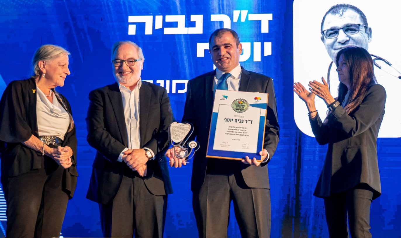 ד"ר נביה יוסף מקבל את תעודת פרס דניאלי על הבמה בטקס באיירפורט סיטי